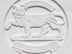 Capbadge of the Leicestershire Regiment on a CWGC headstone